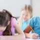Illustration for article titled Heartbreaking: This Student Using Both Of Her Arms To Shield Her Test Has No Idea She’s One Of The Dumbest Kids In Classem/em